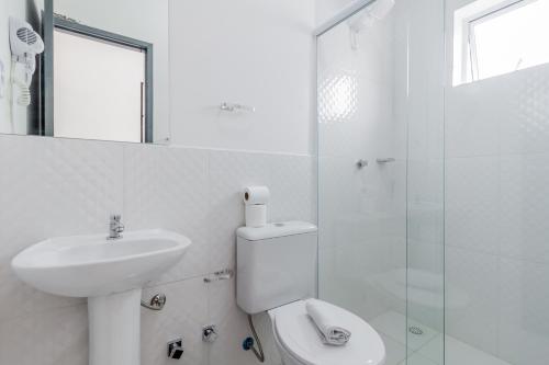 a bathroom with a sink and a toilet and a shower at Blue Ocean Suites - Aeroporto Congonhas in Sao Paulo