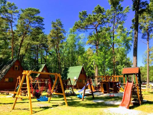 a group of playground equipment in a park at Domki Letniskowe MAJA in Pogorzelica