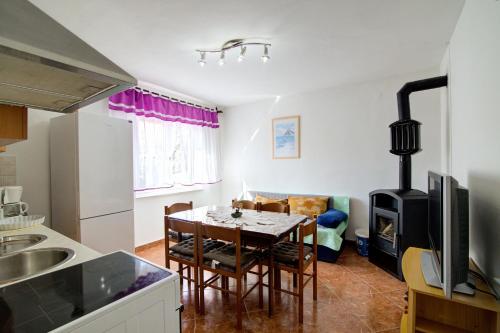 a kitchen and dining room with a table and a stove at Apartments Diego in Sveti Juraj