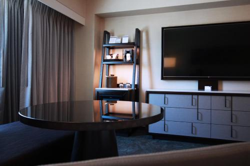 a hotel room with a table and a flat screen tv at Hyatt Regency Sacramento in Sacramento