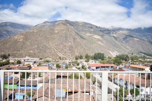 a view of a mountain from the balcony of a building at Hotel California Calca in Calca