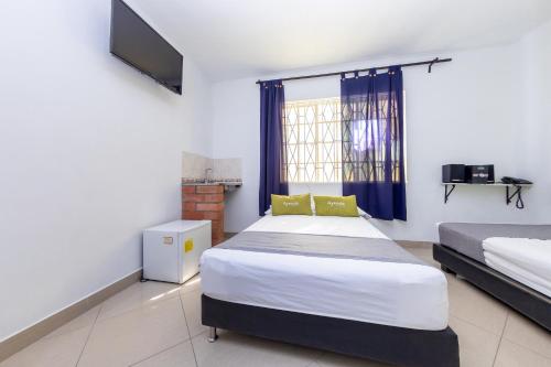 Un pat sau paturi într-o cameră la Ayenda 1231 Paradise Center