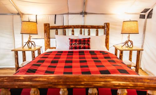 a bedroom with a checkered bed with two lamps at Boulder Mountain Resort in Revelstoke