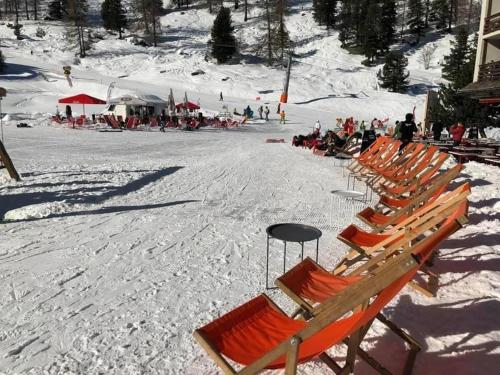 a row of chairs in the snow on a ski slope at Chez Chantal in Siviez