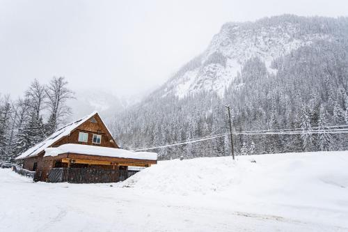 a barn covered in snow in front of a mountain at Boulder Mountain Resort in Revelstoke