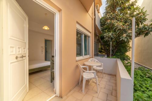 a door leading to a patio with a table and chairs at Akti Galinis in Kalyves
