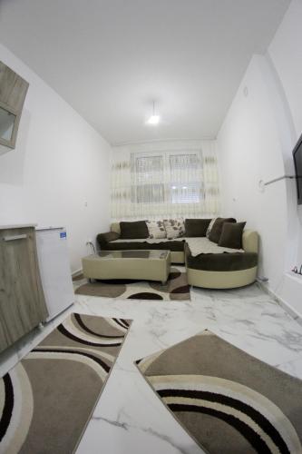 a living room with a couch and a table at APARTMANTES CENTER!!! in Novi Pazar