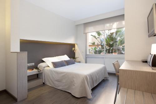Postel nebo postele na pokoji v ubytování Aparthotel Silver