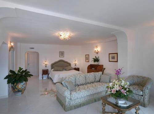 a living room filled with furniture and a fireplace at Hotel Villa Brunella in Capri