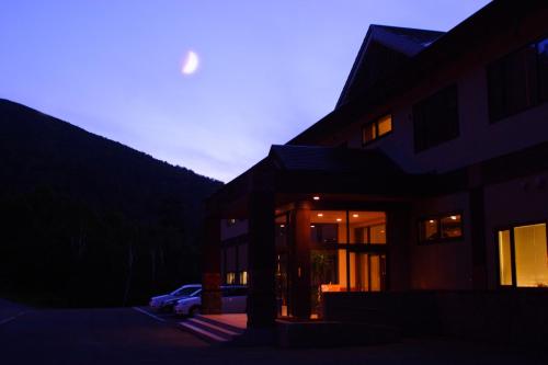 a building with a car parked in front of it at Kamihoroso in Kami-furano