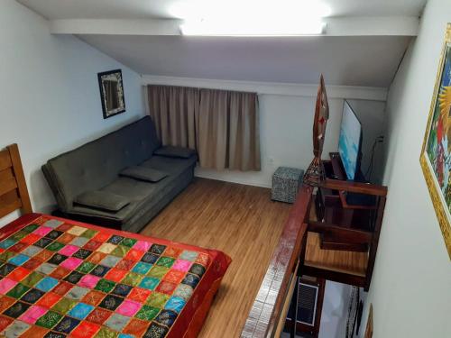 a living room with a bed and a couch at Casa De Praia Maranduba in Ubatuba