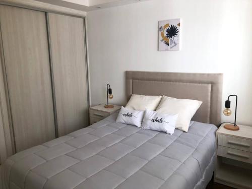 a bedroom with a large bed with white pillows at Plaza Colon in Mar del Plata