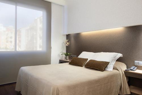 Ένα ή περισσότερα κρεβάτια σε δωμάτιο στο Aparthotel Silver