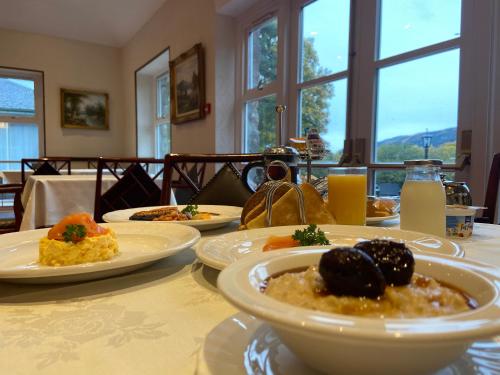 a table with plates of food on top of it at Westlands of Pitlochry in Pitlochry