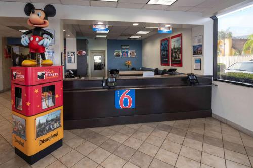 a lobby of a hotel with a mickey mouse standing on a counter at Motel 6-Anaheim, CA - Maingate in Anaheim
