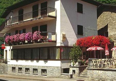 a building with flowers on the balconies of it at Ristorante Vedeggio in Isone