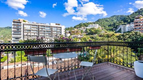 a balcony with chairs and a view of a city at PIER 57 - 711 Fabulous & Dreamy 1 BR Romantic Zone in Puerto Vallarta