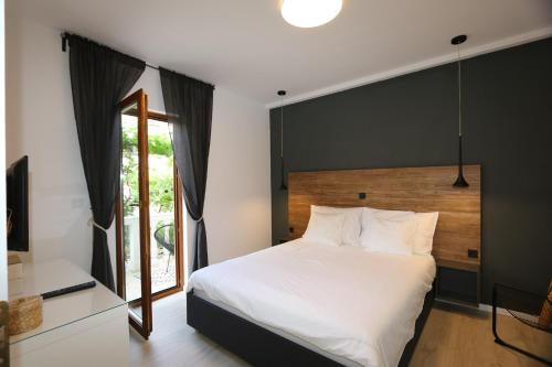 a bedroom with a large white bed and a window at Apartment in Silo with Two-Bedrooms 7 in Šilo