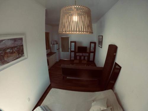 a living room with a chandelier and a room with a couch at Luxy in Maldonado