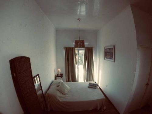 a bedroom with a bed in front of a window at Luxy in Maldonado