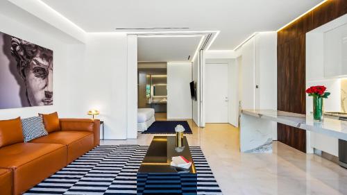 a living room with a couch and a table at PIER 57 - 211 Luxurious & Modern 1 BR Romantic Zone in Puerto Vallarta