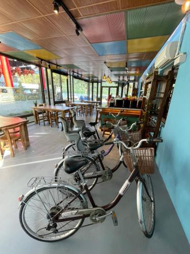 two bikes parked in a restaurant with tables and chairs at Lakeside 46 in Chinan