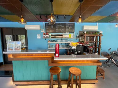 a blue kitchen with a counter with stools at Lakeside 46 in Chinan