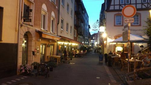 an empty street at night with people sitting at tables at Mosel Panorama in Zell an der Mosel