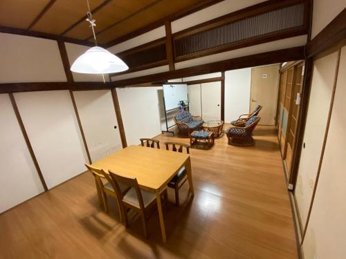 a living room with a wooden table and chairs at 縁 Enishi in Hakone