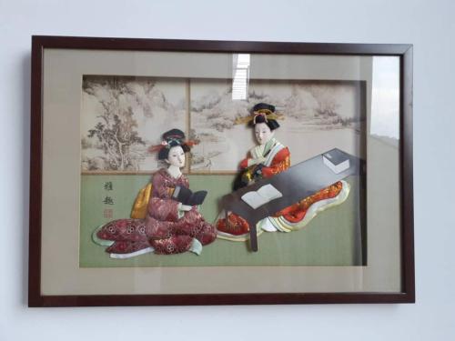 a framed picture of two women in geisha at Empire Damansara Homes by Cities Homes Malaysia in Petaling Jaya