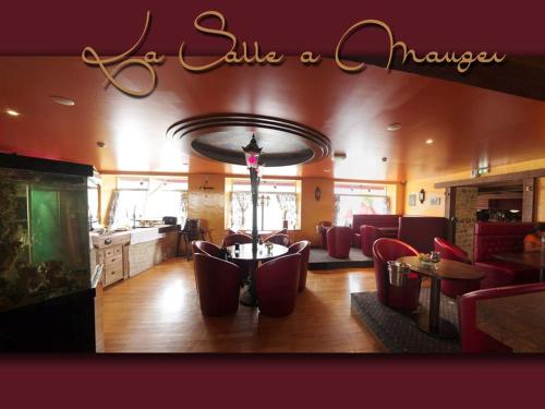Les Chambres du Sillon في Pleubian: غرفة معيشة مع كراسي حمراء وطاولة