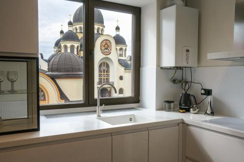 a kitchen with a window view of a church at Elite Loft Apart in Kolomiya