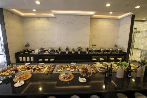 a table with a bunch of food on it at TIME Onyx Hotel Apartments in Dubai