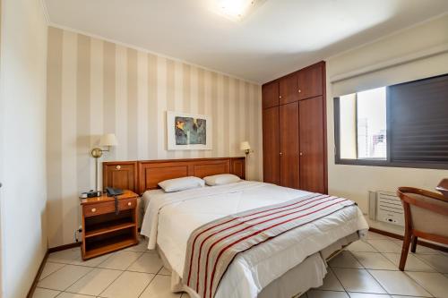 a bedroom with a large bed and a window at Capital O Park Tower, Campinas in Campinas