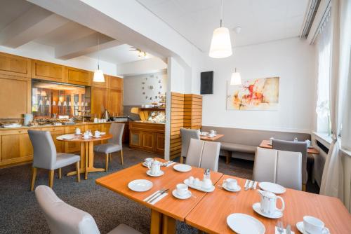 a dining room table and chairs in a kitchen at Hotel Wanner in Böblingen