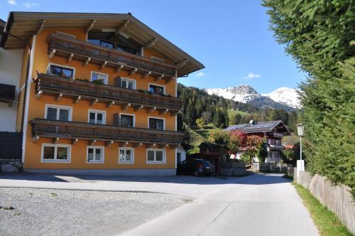 a large orange building on the side of a road at Appartement Wenger in Bad Hofgastein