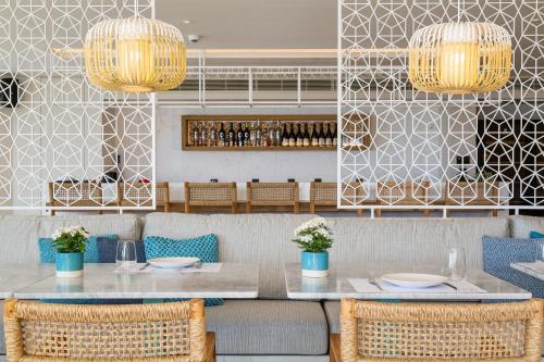 a dining room with a table and chairs at Vathi Cove Luxury Resort & Spa in Chrysi Ammoudia