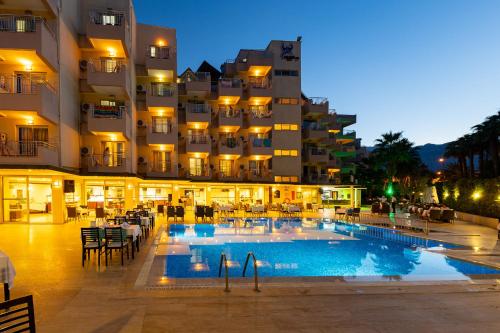 a hotel with a swimming pool in front of a building at Viking Nona Beach in Kemer