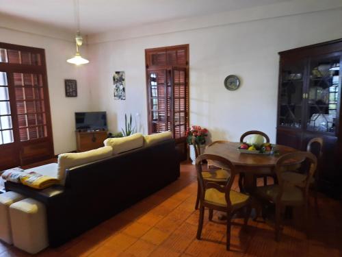a living room with a couch and a table at Quintinha das Lombas in Porto Santo