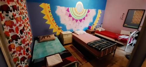 a small room with two beds and a mirror at Shantihome in Izmir