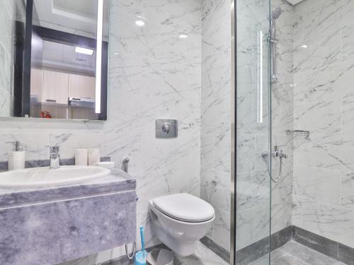 a bathroom with a toilet and a sink and a shower at OYO 617 Home 610, Mag 555 in Dubai