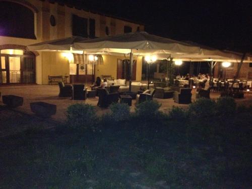 a restaurant with tables and chairs at night at Antico Noce in Granarolo dellʼEmilia
