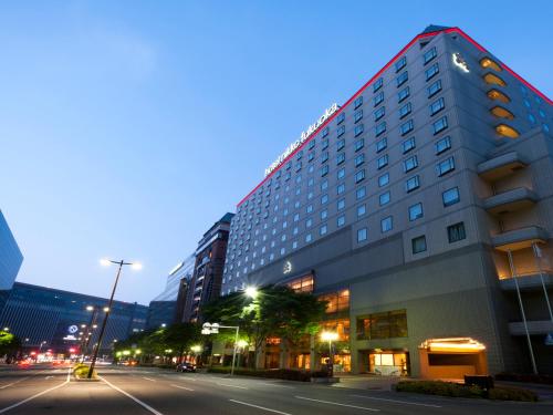a tall building on a city street at night at Hotel Nikko Fukuoka in Fukuoka