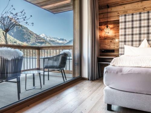 a bedroom with a balcony with a bed and a table at Apartment Appartement Mont Blanc by Interhome in Sölden