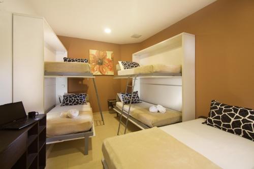 a room with bunk beds and a desk with a laptop at Tai Hoe Hotel in Singapore