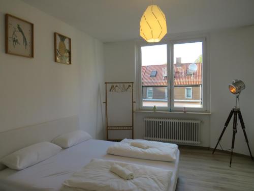 a bedroom with two beds and a window and a camera at L8 Street Monteurwohnung - Kaiser-Friedrich-Str in Pforzheim