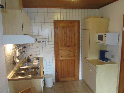 a small kitchen with a sink and a refrigerator at Mosel Panorama in Zell an der Mosel