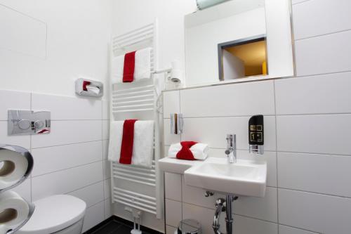 a white bathroom with a sink and a toilet at INA Boutique 072 Hamburg St Georg in Hamburg