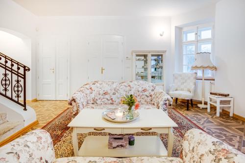 a living room with a couch and a table at Lovecký zámeček pod Milešovkou in Teplice