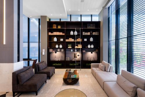 a living room with a couch and chairs and a table at Mercure Curitiba Batel in Curitiba